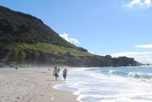 Strolling along the beach at Maunganui